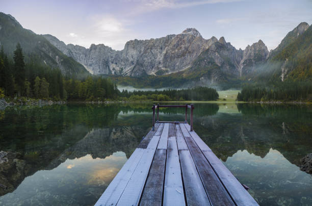 istock wooden bridge over a mountain lake 873780940