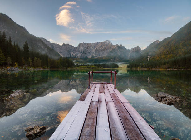 istock wooden bridge over a mountain lake 873780986