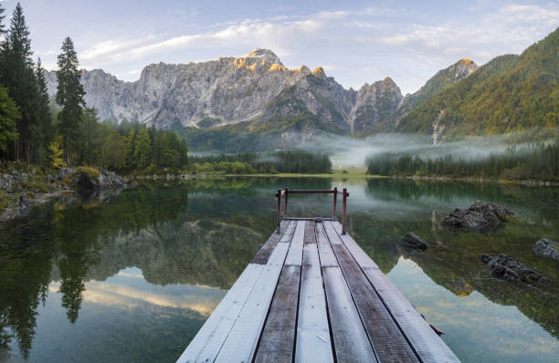 istock wooden bridge over a mountain lake 873781112