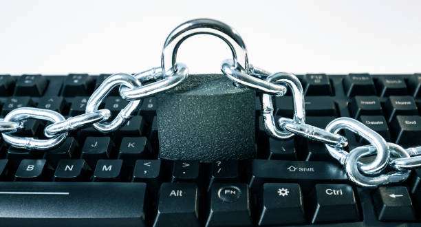 istock Computer virus protection metaphor, metal chain padlock and keyboard 873781172