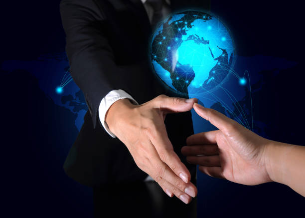 istock businessman will handshaking for business relationship light blue glowing line networking circular earth on world map background as business, technology, commitment, welcome and global concept. 873784088
