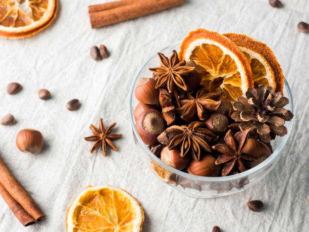 istock Winter ingredients nuts, cones, oranges, cinnamon star anise in a bowl. Rustic style 873786762