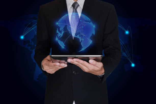 istock Businessman hand hold tablet and light blue polygon glowing technolgoy world map as business, technology, innovation and globalization concept. 873790448