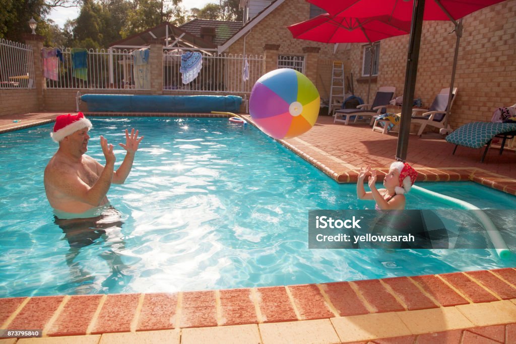 Summer Christmas Man and child in the pool for an Australian summer Christmas Australia Stock Photo