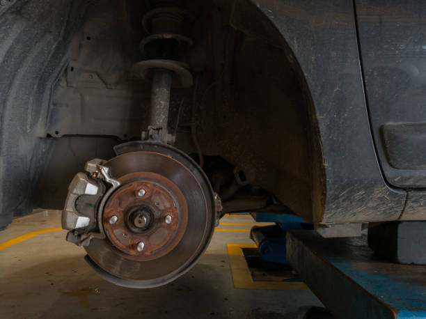 istock in a garage. Auto mechanic repairing . 873798038