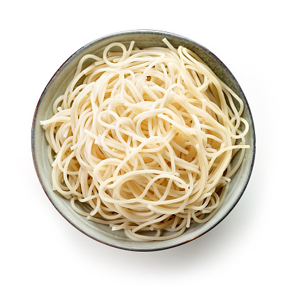 bowl of boiled spaghetti pasta isolated on white background, top view