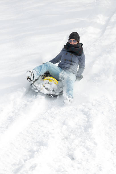 istock young woman sledging in the deep snow 873799806