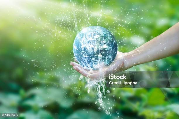Water Pouring On Planet Earth Placed On Human Hand For Saving Resources And Heal The World Campaign Environment Issues Elements Of This Image Furnished By Nasa Stock Photo - Download Image Now