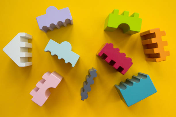 istock Multicolored baby cubes of different shapes on a yellow background. 873810534