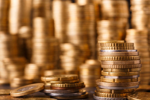istock Golden coin stacks, rich money background 873810686