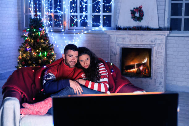 Couple watching TV at home