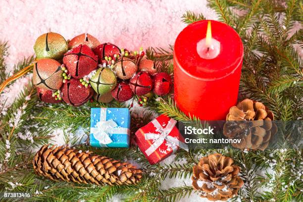 Christmas Or New Year Card Burning Red Candle Cones Giftboxes Toys On Fir Tree Branches And Snow Close Up Image Stock Photo - Download Image Now