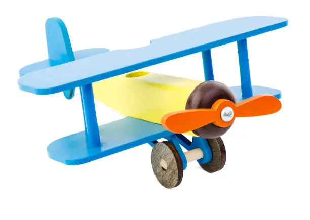 Photo of Children's plane of yellow blue color made of wood isolated on white background.