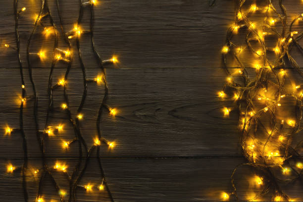 istock Christmas lights border on grey wooden background 873815204