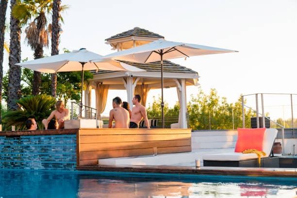 istock Friends relaxing in a luxury hot tub outdoors at sunset 873818656