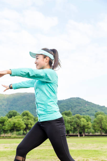 istock female athlete stretching against sky 873826084