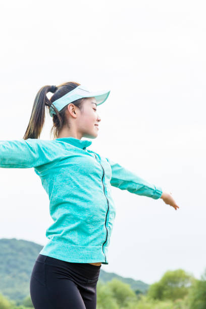 istock female athlete stretching against sky 873826438