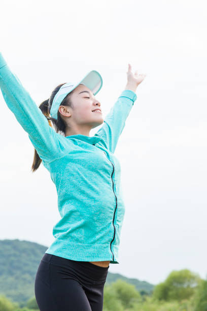 istock female athlete stretching against sky 873826544
