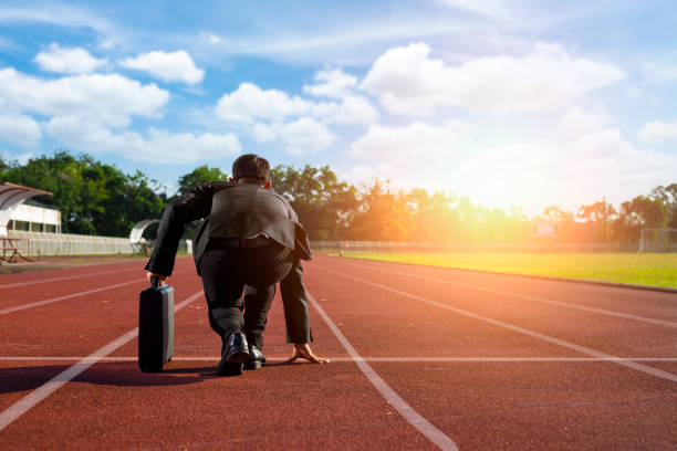 istock A businessman on a track ready to run 873828740
