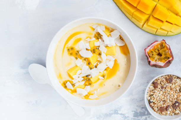 istock Mango smoothie bowl with coconut, granola and passion fruit. 873832534