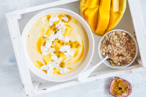 istock Mango smoothie bowl with coconut, granola and passion fruit. 873832814