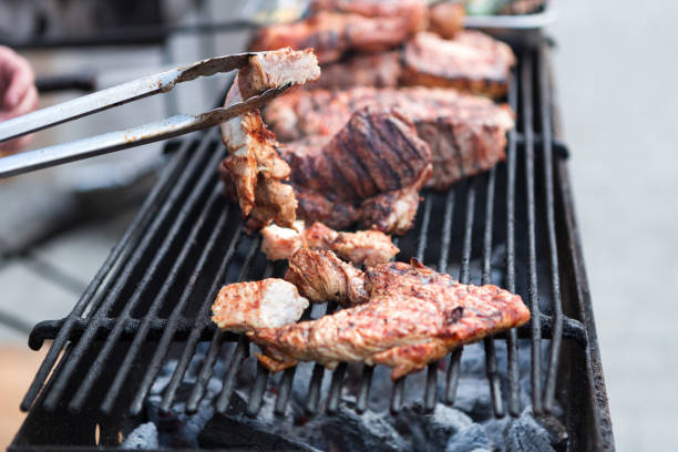 istock Pork ribs cooking on grill at bbq party 873834598