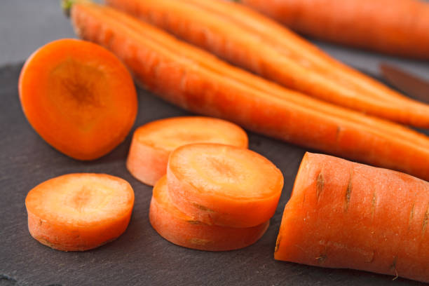 istock Rustic slate stone plate with carrots, cooking backgroung. 873838808