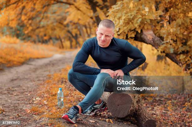 A Young Athletic Jogger Feels A Strong Pain In The Muscle After Cramping Stock Photo - Download Image Now