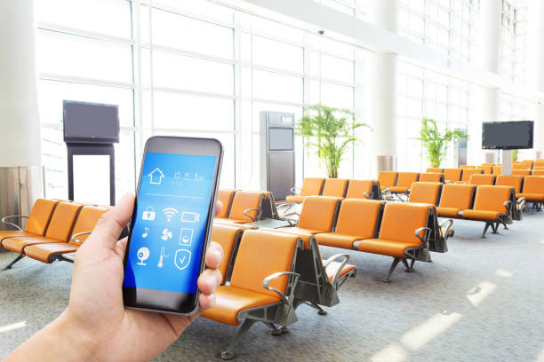 istock smart phone with smart home with modern airport hall 873842560