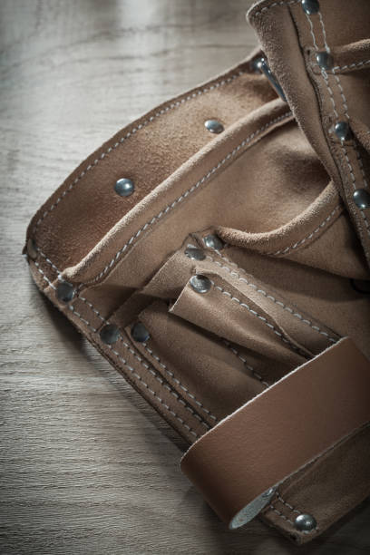 istock Leather construction belt on wooden board 873842754