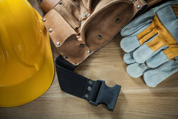 istock Leather construction belt protective gloves building helmet on w 873842810