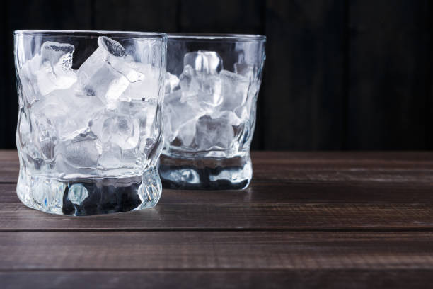 istock Glasses with ice cubes on dark background 873844978
