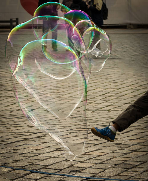 istock Leg of a young boy kicking big soap bubbles 873846394