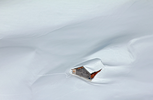 Snowed-in mountain hut in the Alps