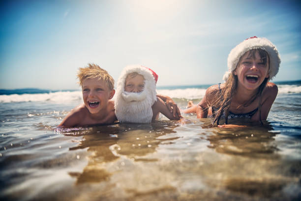 istock Kids playing in sea during summer Christmas 873849504