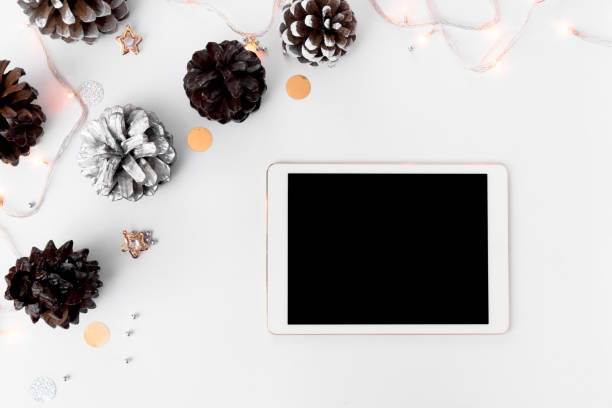 istock stylish tablet mockup for christmas time, christmas decorations on isolated white screen, flat lay top view. 873853204