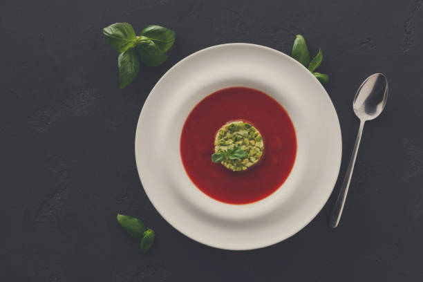istock Cold tomato soup gazpacho with avocado top view 873853226