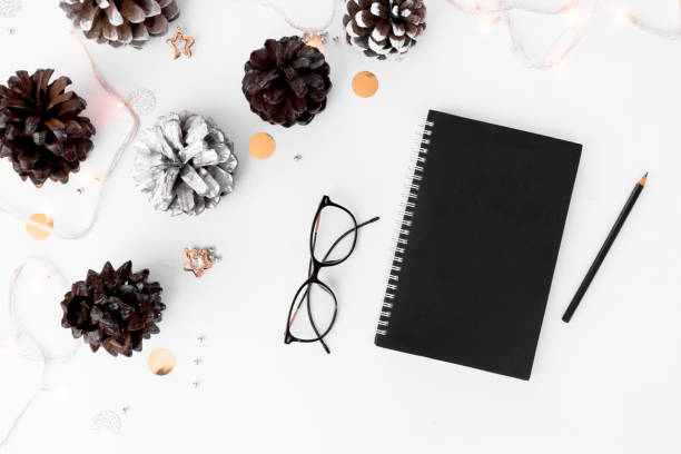 istock Notebook diary christmas mockup, pine cones and decorations on white background, flat lay top view. 873853400