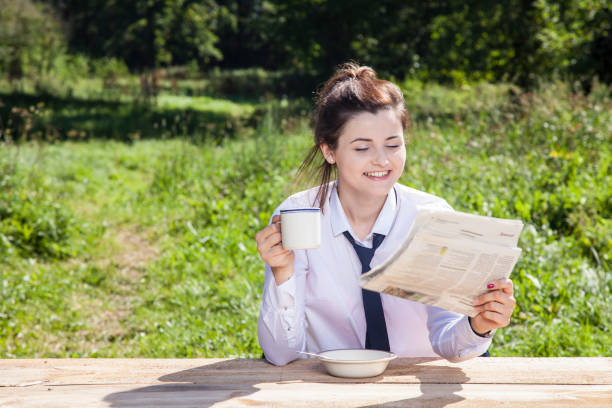 istock business woman reading a newspaper while drinking coffee 873853570