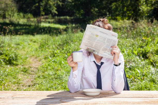 istock business woman hiding behind a newspaper 873854258