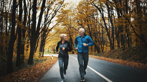 istock Senior couple jogging in a forest. 873854378