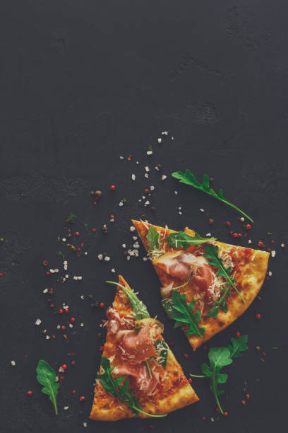 istock Pizza with prosciutto and rocket salad copy space 873856626