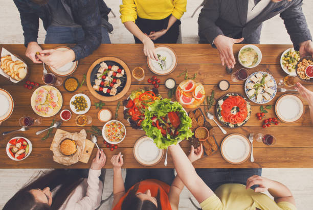 istock People eat healthy meals at served table dinner party 873857632