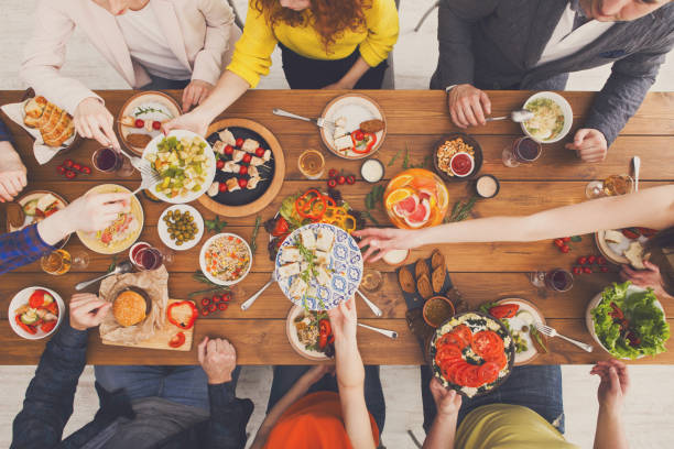 istock People eat healthy meals at served table dinner party 873857738