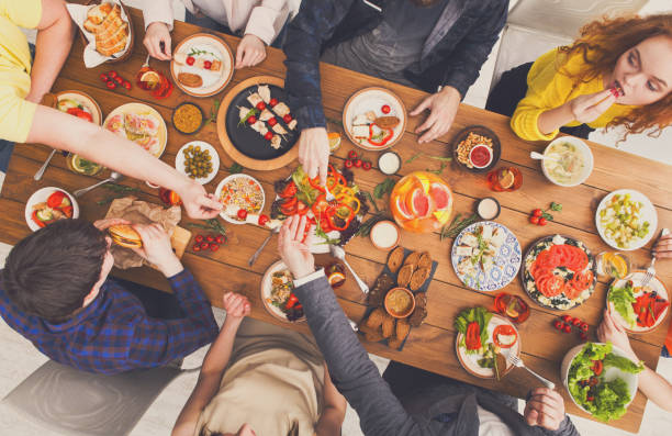 istock People eat healthy meals at served table dinner party 873857814