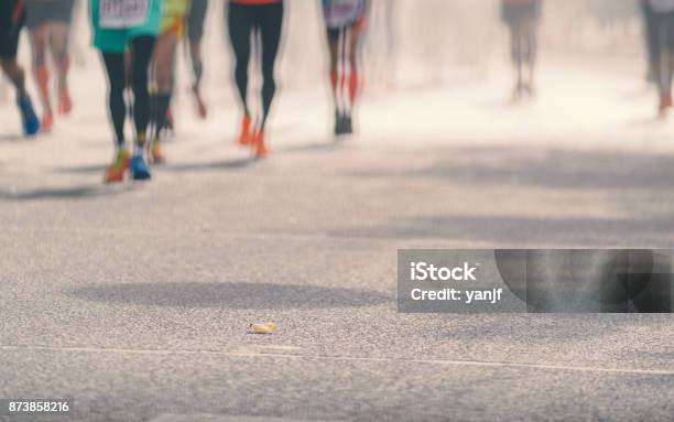 Low Angle View Of Marathon Runners Running In Sunny Street Blurred Abstract Motion Group Of Runners City Street Sport Background Fitness And Healthy Lifestyle Sport Activity Stock Photo - Download Image Now