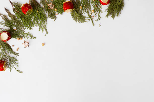 istock Top view on nice Christmas gift wrapped in white gift paper, Christmas tree decorations on white wooden background with sparkling stars. New Year, hol 873858376