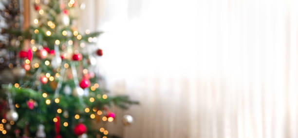 out of focus holiday background with christmas tree stock photo