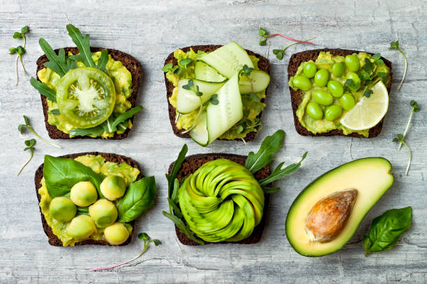istock Fresh avocado toasts with different toppings. Healthy vegetarian breakfast with rye wholegrain sandwiches 873864896