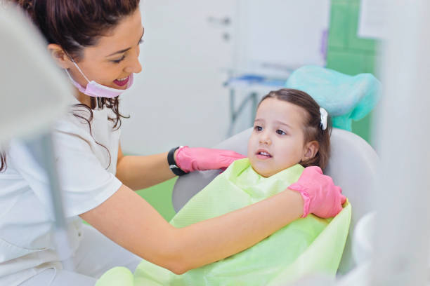 istock Adorable little girl at dentist's office 873865014